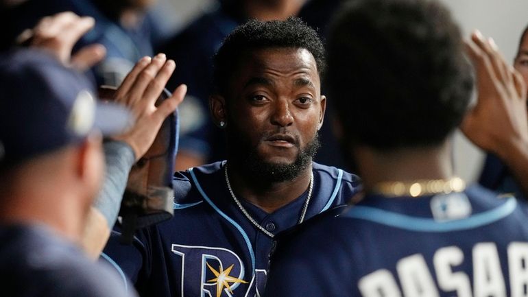 Tampa Bay Rays' Vidal Bruján is congratulated in the dugout...