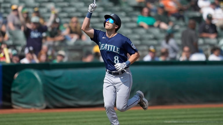 Seattle Mariners' Dominic Canzone (8) celebrates after hitting a two-run...