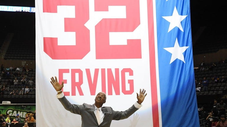 Julius "Dr. J' Erving celebrating his number retired and raised...