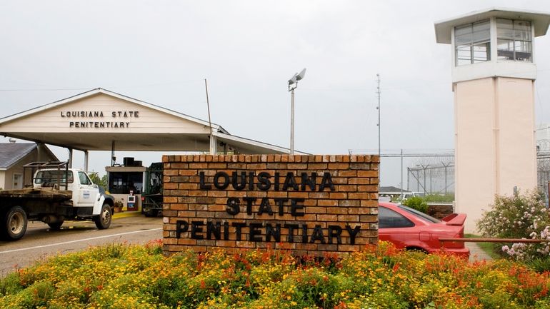 Vehicles enter at the main security gate at the Louisiana...