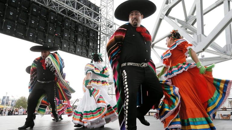 Members of a Ballet Folklorico perform outside AT&T stadium as...