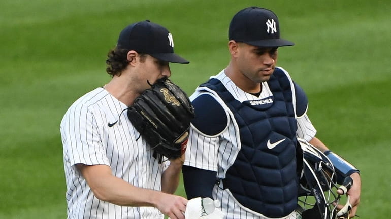 Yankees starting pitcher Gerrit Cole and catcher Gary Sanchez walk...