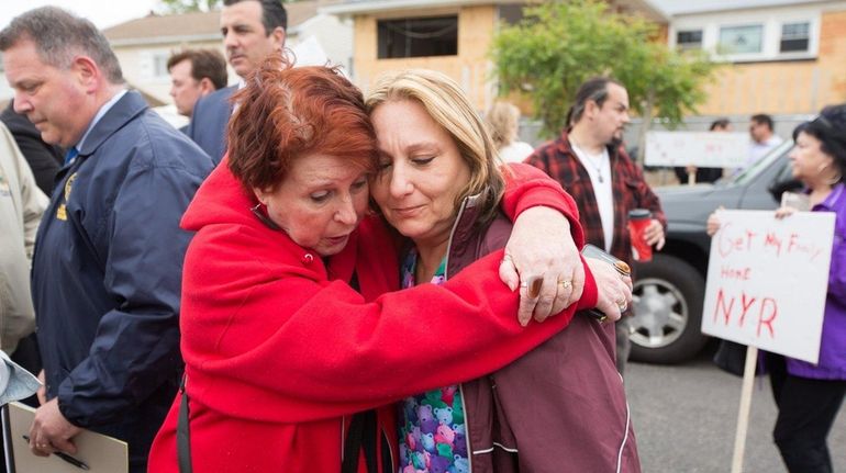 Freeport residents Lois Howes, left, and Eva Rowan, embrace on...