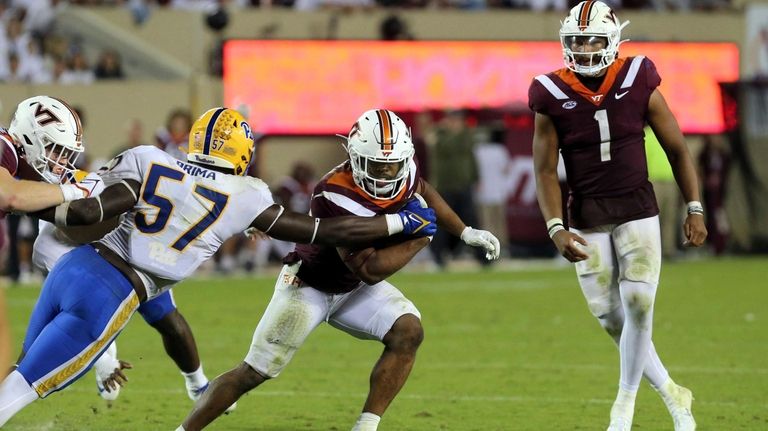 Pittsburgh defender Bam Brima (57) reaches for Virginia Tech running...