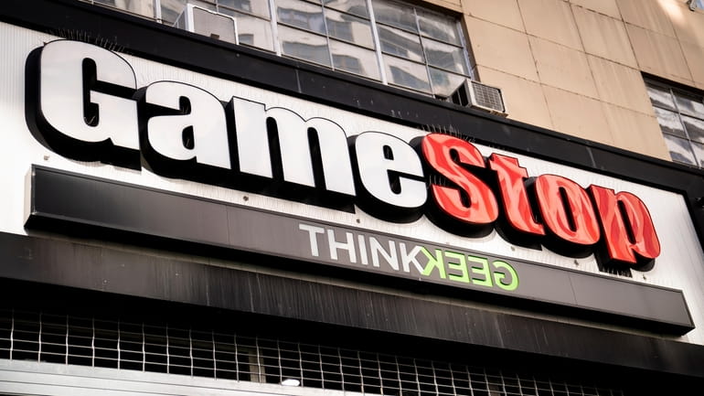 Pedestrians pass a GameStop store on 14th Street at Union...
