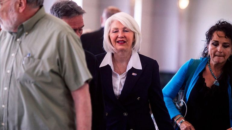 Former Mesa County, Colo., county clerk Tina Peters, center, arrives...