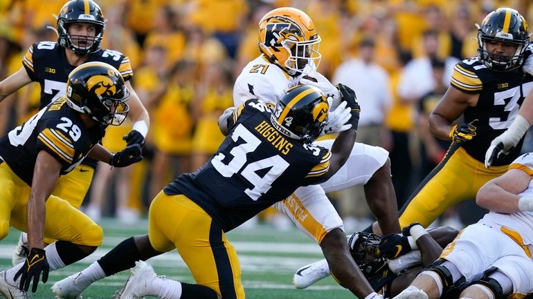 Kent State running back Joachim Bangda (21) is tackled by...