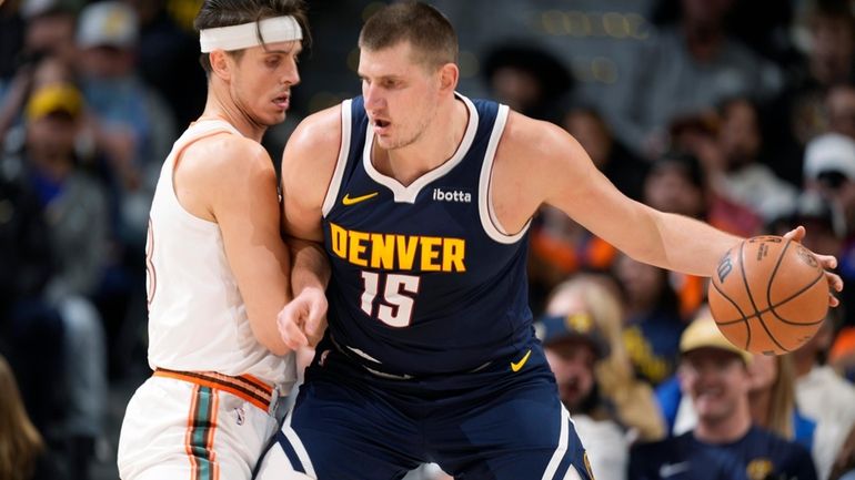 Denver Nuggets center Nikola Jokic, right, posts up against San...