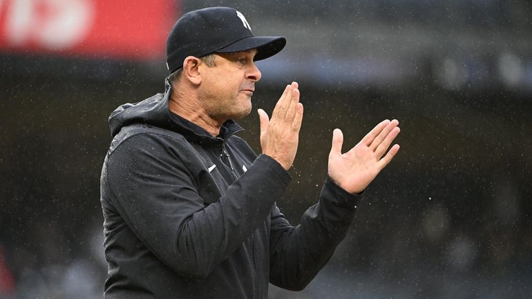 Yankees manager Aaron Boone approaches an umpire during the eighth...