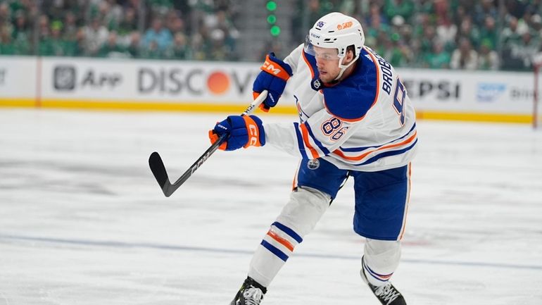 Edmonton Oilers defenseman Philip Broberg shoots against the Dallas Stars...