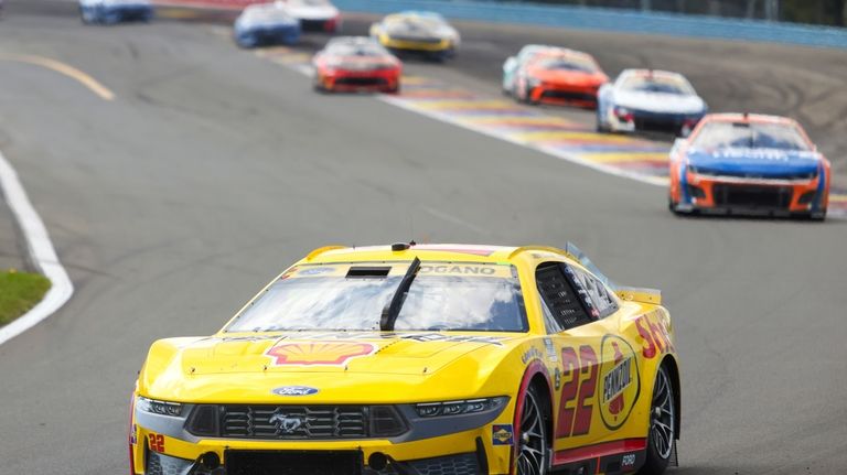 Joey Logano (22) compete in a NASCAR Cup Series auto...