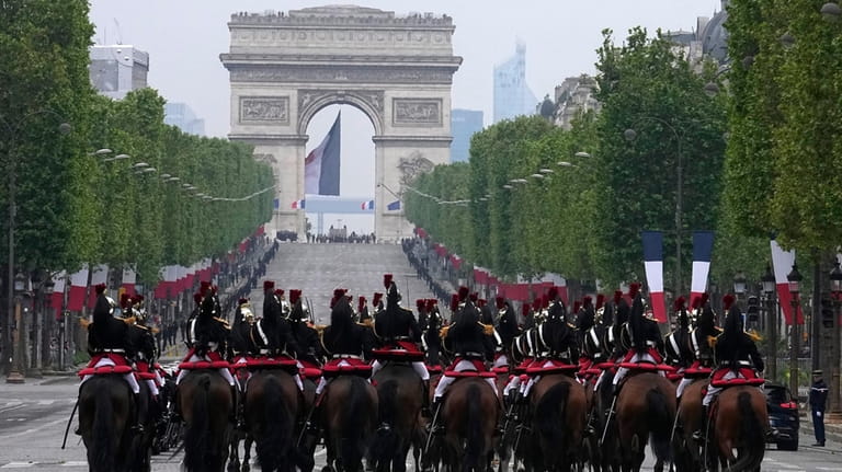 Republican Guards ride up the Champs-Elysees avenue during ceremonies marking...