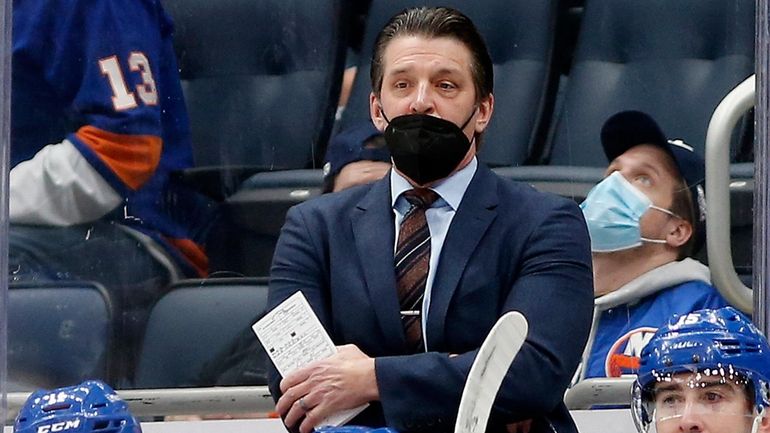 Interim head coach Lane Lambert of the Islanders looks on from...