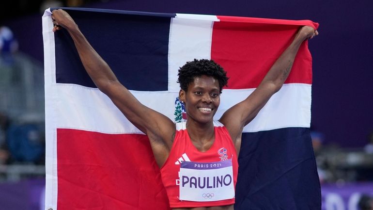 Marileidy Paulino, of the Dominican Republic, celebrates winning the women's...