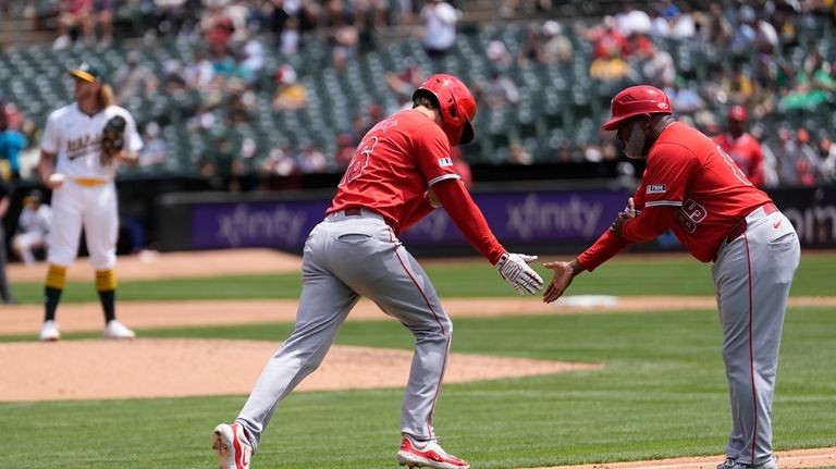 Los Angeles Angels' Mickey Moniak, front left, is congratulated by...