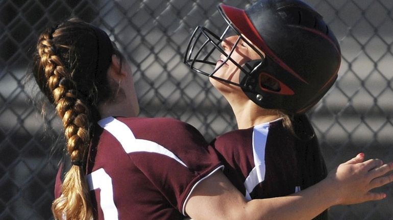 Mepham shortstop Kelsey Vandewater right, gets congratulated by Kara Castaldo...