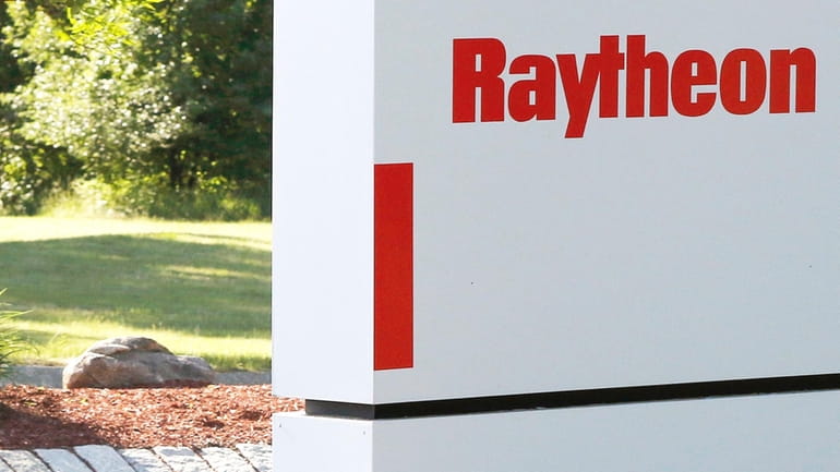 A sign stands at the road leading to the Raytheon...