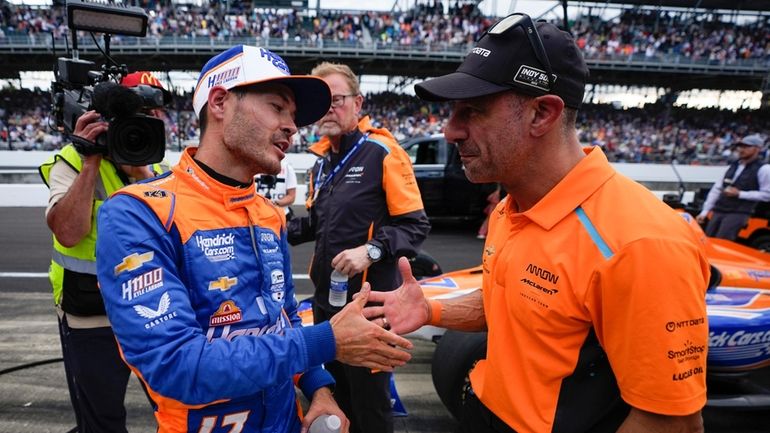 Kyle Larson, left, shakes hands with Tony Kanaan following the...