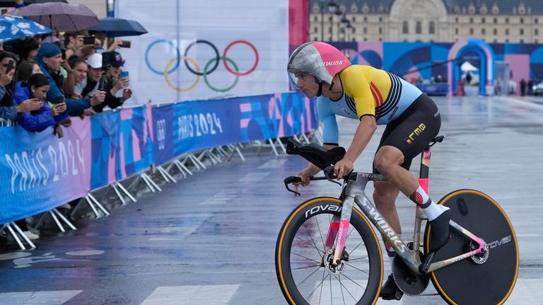 Remco Evenepoel, of Belgium, competes in the men's cycling time...