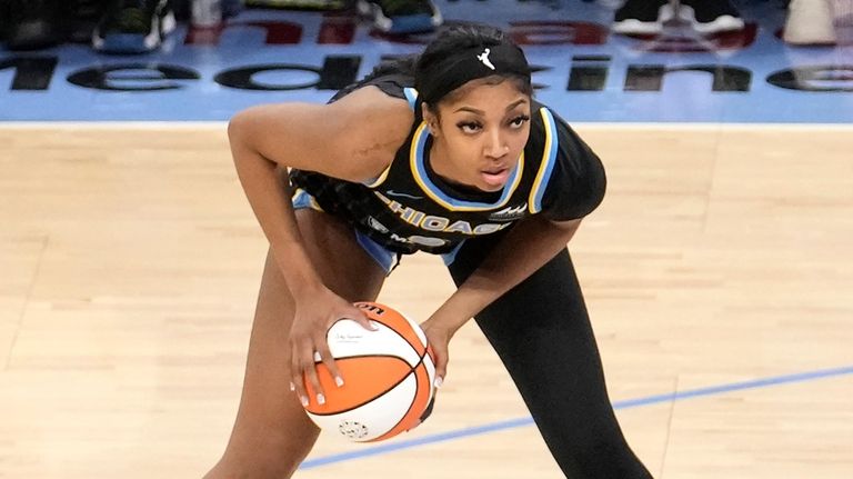 Chicago Sky's Angel Reese looks to pass during the team's...