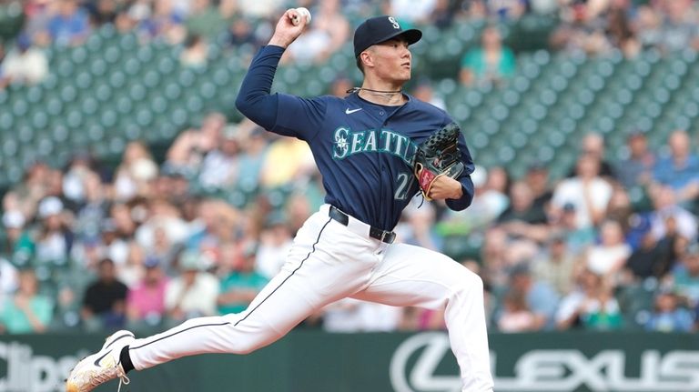 Seattle Mariners starting pitcher Bryan Woo throws during the first...