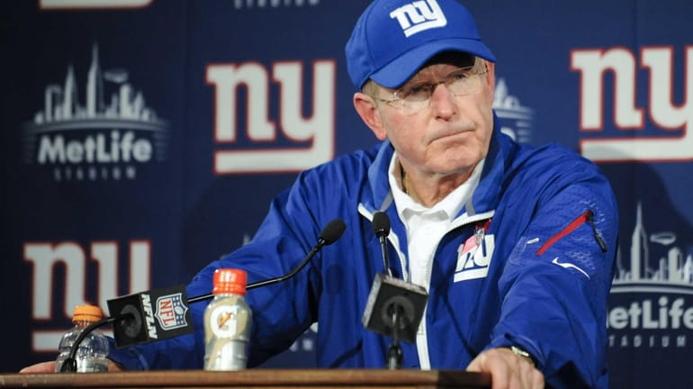 Tom Coughlin responds to questions during a news conference after...