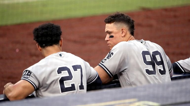 Giancarlo Stanton and Aaron Judge of the Yankees talk in...