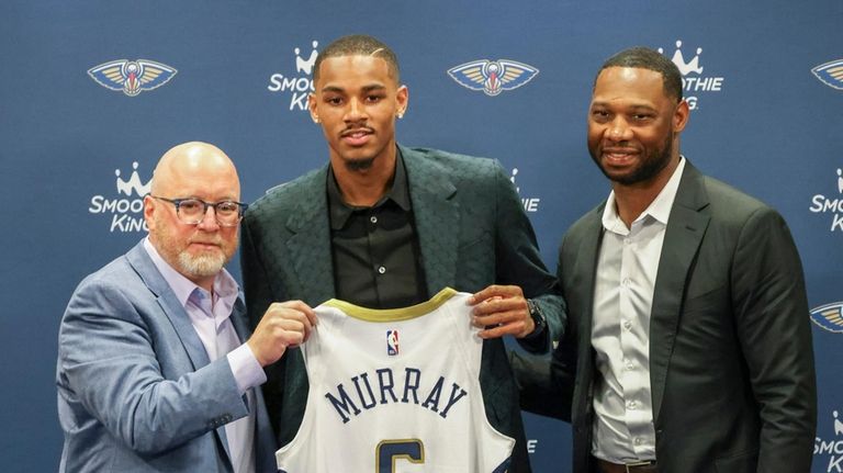 New Orleans Pelicans new player Dejounte Murray, center, joined by...