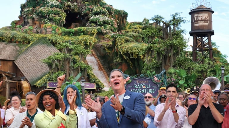 With Princess Tiana, Walt Disney World president Jeff Vahle cheers...