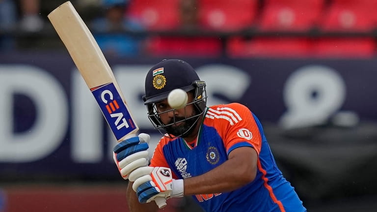 India's captain Rohit Sharma plays a shot during the ICC...
