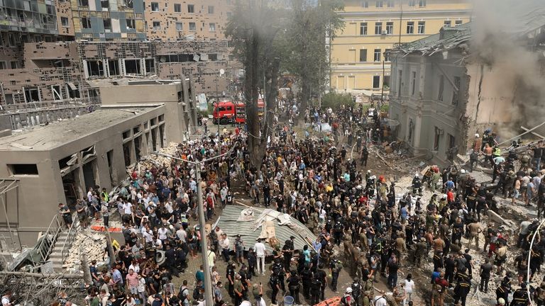 Rescuers and volunteers clean up the rubble and search for...