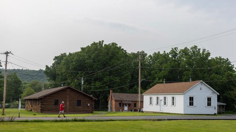 A man walks outside the Onondaga Nation's longhouse, where meetings...