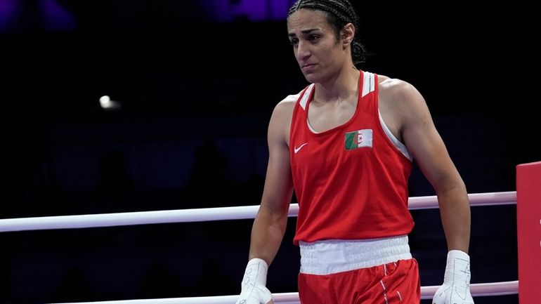 Algeria's Imane Khelif, reacts after defeating Italy's Angela Carini in...