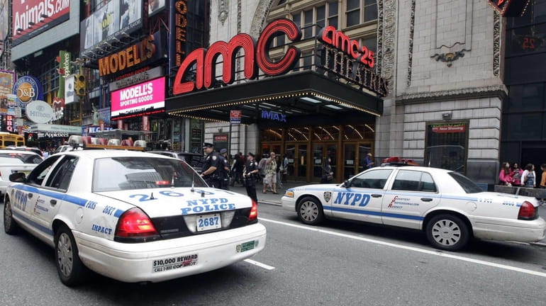 Police officers are seen outside a movie theater screening "The...