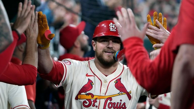 St. Louis Cardinals' Pedro Pages is is congratulated by teammates...