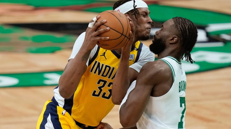 Indiana Pacers center Myles Turner (33) drives against Boston Celtics...