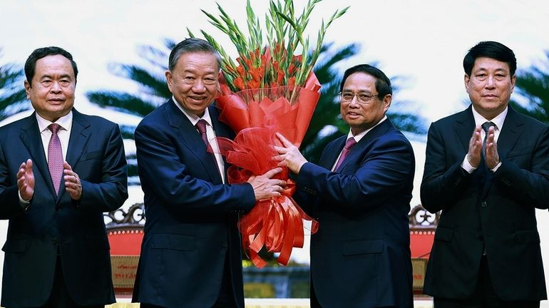 Vietnamese Prime Minister Pham Minh Chinh, right, congratulates Vietnamese President...