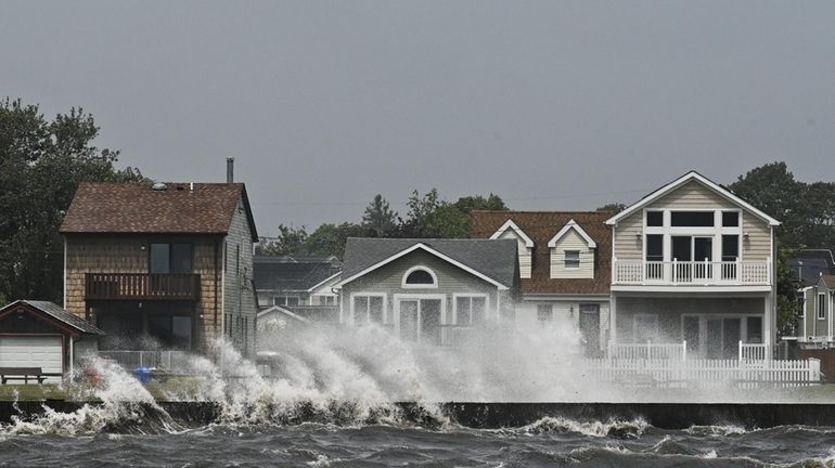 Waves crash along the shore of Patchogue as Tropical Storm...