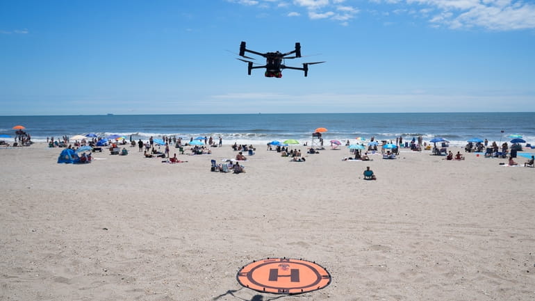 A drone lands for a battery swap at Rockaway Beach...