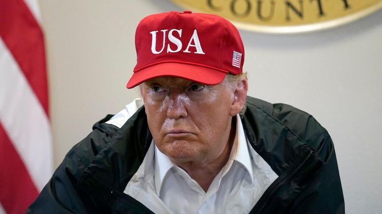 President Donald Trump listens during a briefing about Hurricane Laura...