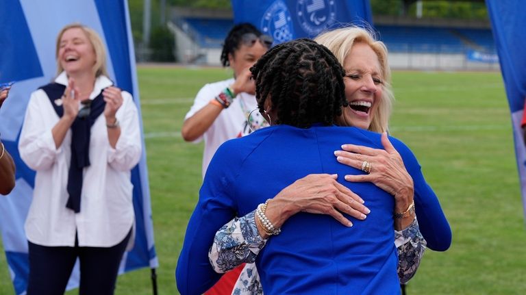 First lady Jill Biden, right, hugs U.S. track and field...