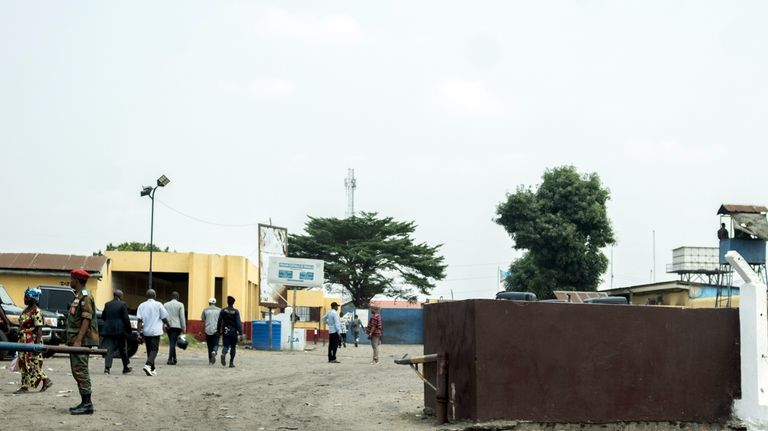 People walk past the Makala Central prison in Kinshasa, Congo,...