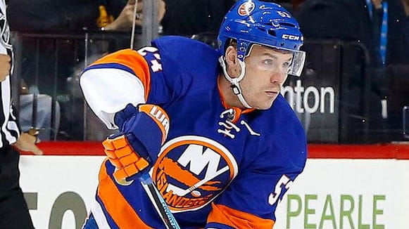 Casey Cizikas of the New York Islanders plays the puck...