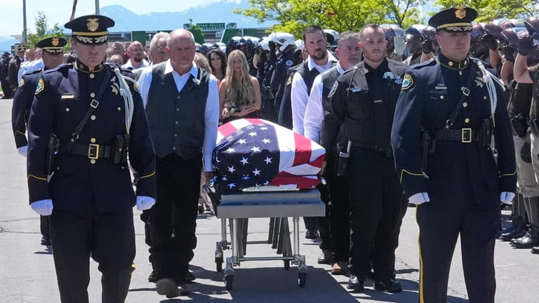 The casket of Santaquin Police Sgt. Bill Hooser is carried...