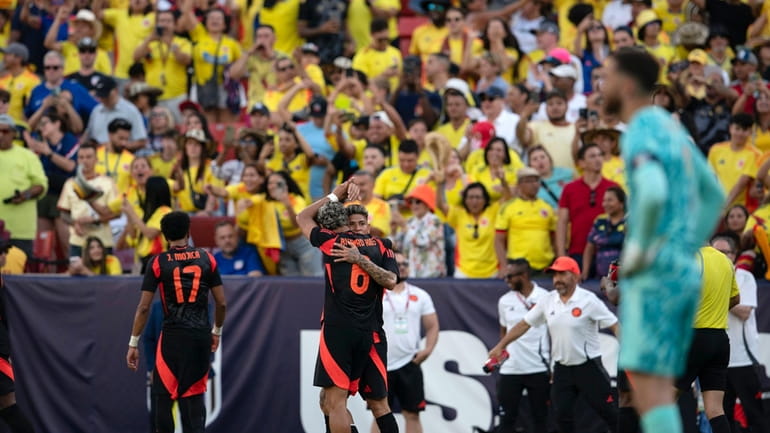 Colombia midfielder Jorge Carrascal, center rear, celebrates with Richard Rios...