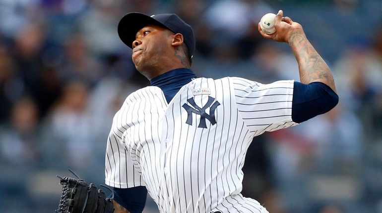 Aroldis Chapman #54 of the New York Yankees pitches in...