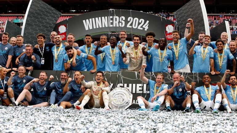 Manchester City players celebrate winning the FA Community Shield soccer...