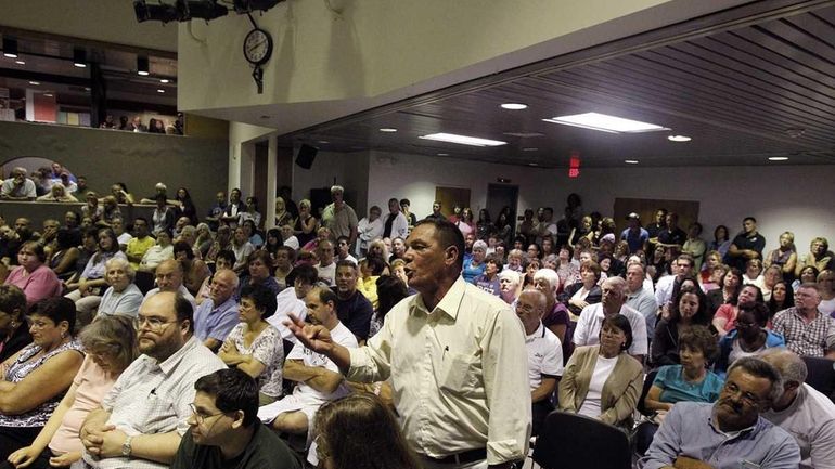 Resident Thomas Scarpantonio asks a question at a meeting about...