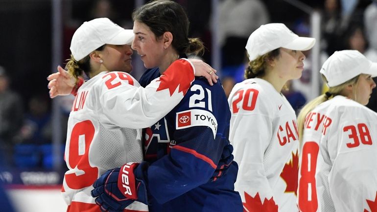 United States forward Hilary Knight, right, hugs Canada forward Marie-Philip...