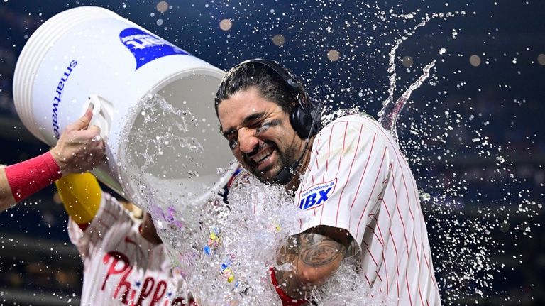 Philadelphia Phillies' Nick Castellanos is doused by teammates Brandon Marsh...